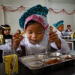 Siswa sekolah menikmati Program Makan Bergizi Gratis sebagai upaya peningkatan kualitas sumber daya manusia Indonesia.
